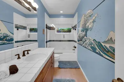 a bathroom with a sink and a toilet and a mirror at Fairway Retreat, Stylish Coastal Home Near Golf, Beaches & Carlsbad Fun in Encinitas