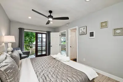 a bedroom with a bed and a ceiling fan at Seabreeze 1BR, Walk to Sand, Pet Friendly, Parking, Fire Pit Access in Carlsbad