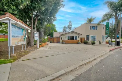 a house with a sign in front of a driveway at Luxury Beach Duplex, Sleeps 9, Dog-Friendly, AC, Fire Pit & Grill in Carlsbad