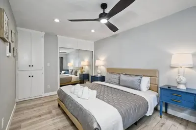 a bedroom with a bed and a ceiling fan at Luxury Beach Duplex, Sleeps 9, Dog-Friendly, AC, Fire Pit & Grill in Carlsbad