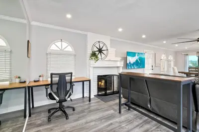 a home office with two desks and a fireplace at Luxury Beach Duplex, Sleeps 9, Dog-Friendly, AC, Fire Pit & Grill in Carlsbad