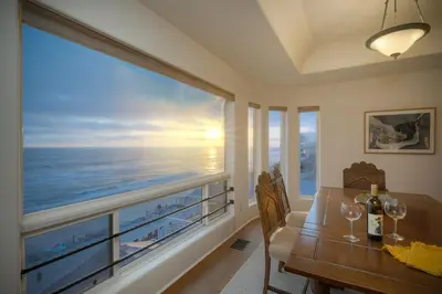a dining room with a view of the ocean at Exclusive Beachfront Duplex in Carlsbad Village Ocean Views, Sleeps 9 in Carlsbad