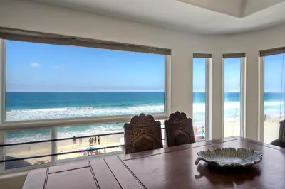 a dining room with a view of the beach at Exclusive Beachfront Duplex in Carlsbad Village Ocean Views, Sleeps 9 in Carlsbad