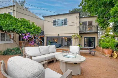 a patio with a couch and chairs and a table at Steps to Beach, 2BR Dog Friendly Home with Fire Pit in Carlsbad