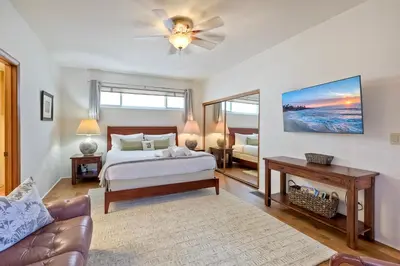 a bedroom with a bed and a couch at Direct Beach Access, Views, Carlsbad 2BR Upper Unit in Carlsbad