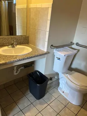 a bathroom with a sink and a toilet and a mirror at San Diego Inn in San Diego