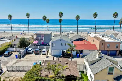 an aerial view of a beach with palm trees and houses at Oceanside Bungalow, Walk to Beach & Pier, Private Hot Tub, Beach Gear in Oceanside