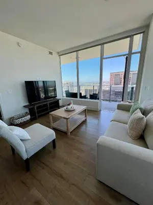 a living room with a couch and a tv at The Daisy Bright 2BR Stay in Downtown San Diego in San Diego