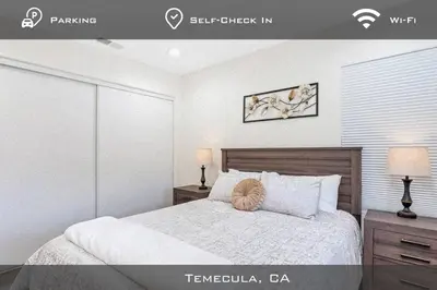 a bedroom with a bed and two lamps and a picture at Spacious Extended Stay Temecula in Temecula