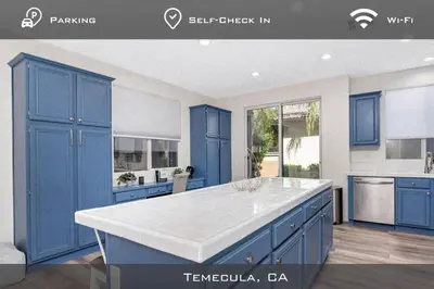 a kitchen with blue cabinets and a white counter top at Spacious Extended Stay Temecula in Temecula