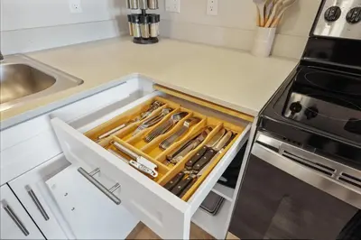 a kitchen with a drawer filled with knives at NEW LUX Modern Retreat Views Parking Workspaces in San Diego