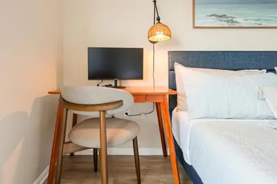 a desk with a chair next to a bed at NEW LUX Modern Retreat Views Parking Workspaces in San Diego