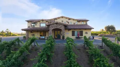a house in the middle of a vineyard at 2 Homes in Bella Vista Rd by AvantStay Sleeps 8 Vineyard Views Patios in Temecula Wine Trail in Temecula
