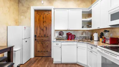 a kitchen with white cabinets and a white refrigerator at New-Build Temecula Villa with King Suite Patio Vineyard Views The Villa by AvantStay in Temecula