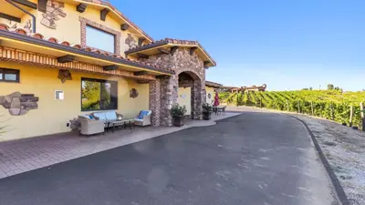 a driveway in front of a house with vines at New-Build Temecula Villa with King Suite Patio Vineyard Views The Villa by AvantStay in Temecula
