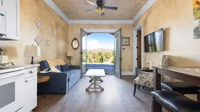 a living room with a blue couch and a window at New-Build Temecula Villa with King Suite Patio Vineyard Views The Villa by AvantStay in Temecula