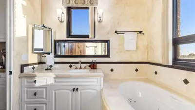 a bathroom with a tub and a sink and mirror at Soaking Tub Vineyard Views Wine Trail Access The Casita at Vines Estate by AvantStay in Temecula