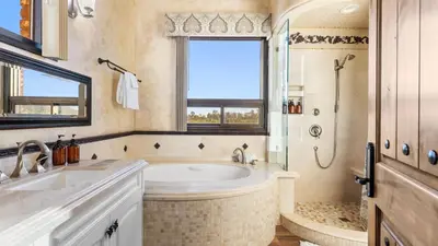 a bathroom with a tub and a shower and a sink at Soaking Tub Vineyard Views Wine Trail Access The Casita at Vines Estate by AvantStay in Temecula