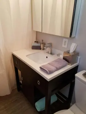 a bathroom with a sink and a mirror at The Hideaway in San Diego