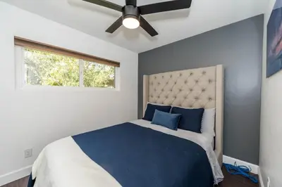 a bedroom with a bed and a ceiling fan at Canyon View in San Diego