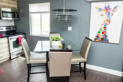 a kitchen with a table and chairs and a dining room at Canyon View in San Diego