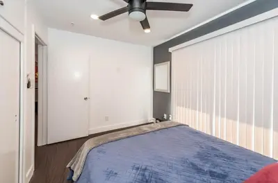 a bedroom with a bed and a ceiling fan at Canyon View in San Diego