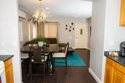 a kitchen and dining room with a table and chairs at Sutra in San Diego
