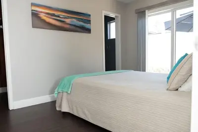 a bedroom with a large bed and a window at Sutra in San Diego