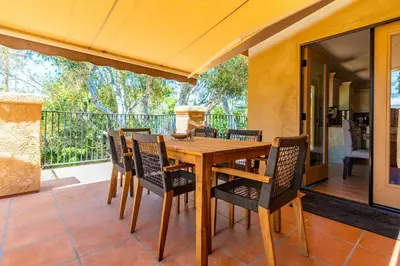 a wooden table and chairs on a patio at Canyon Treehouse in San Diego