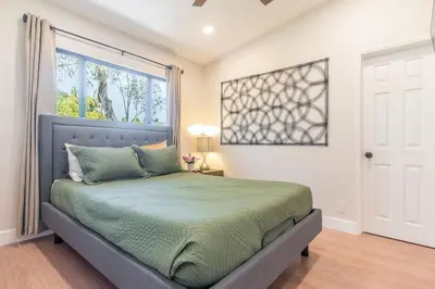 a bedroom with a bed and a large window at Canyon Treehouse in San Diego