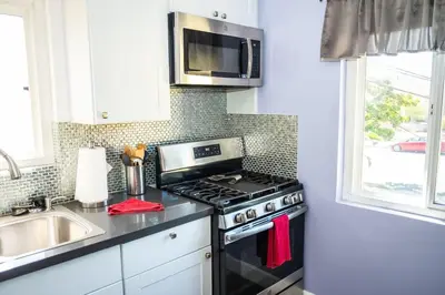 a kitchen with a stove top oven next to a sink at Serenity in San Diego