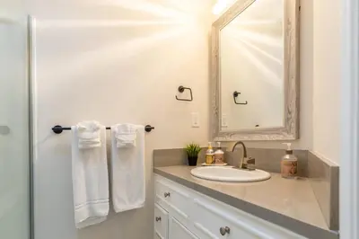 a bathroom with a sink and a mirror at Allure Retreat in San Diego