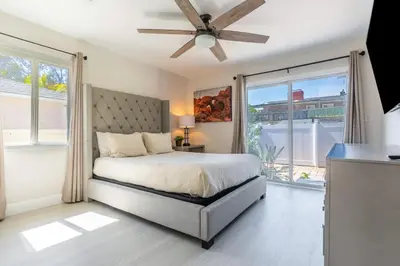 a bedroom with a bed and a ceiling fan at Allure Retreat in San Diego