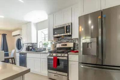 a kitchen with a stainless steel refrigerator and appliances at Allure Retreat in San Diego