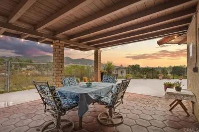 a patio with a table and chairs on a patio at Entire Private Home with 3 Bedrooms 2 Bathrooms, Mountain View, Jetted Tub, 2500 sqft, King Bed,Garage, Available Now in Jamul