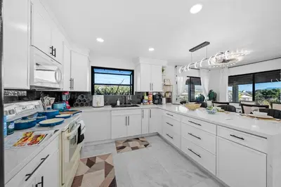 a large white kitchen with white cabinets and windows at Entire Private Home with 3 Bedrooms 2 Bathrooms, Mountain View, Jetted Tub, 2500 sqft, King Bed,Garage, Available Now in Jamul