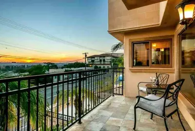 a balcony with a table and chairs and a view of the ocean at Stunning Views, Rooftop Vista, Pool & Spa in San Diego