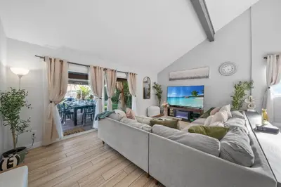 a living room with a large couch and a tv at Entire Private Home with 3 Bedrooms, Hot Tub, King Bed, Garage, Grand View, Available Now in San Diego