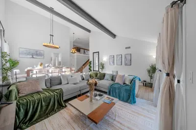 a living room with a couch and a table at Entire Private Home with 3 Bedrooms, Hot Tub, King Bed, Garage, Grand View, Available Now in San Diego