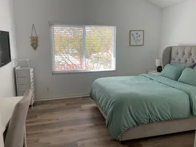 a bedroom with a large bed and a window at Beautifully Remodeled 2BR Prime Irvine Location in Irvine