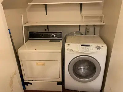 a small kitchen with a washing machine and a washer at Beautifully Remodeled 2BR Prime Irvine Location in Irvine