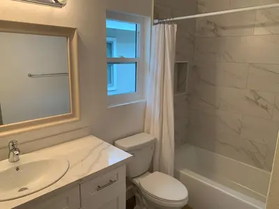 a bathroom with a toilet and a sink and a shower at Beautifully Remodeled 2BR Prime Irvine Location in Irvine
