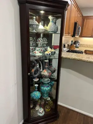 a cabinet filled with vases in a kitchen at Quail Hill Condo in Irvine