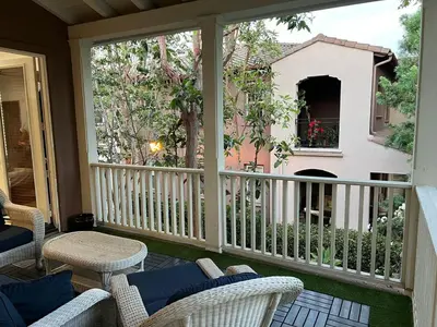a screened in porch with chairs and a window at Quail Hill Condo in Irvine