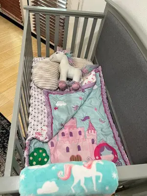 a crib with a blanket and a stuffed animal on it at Quail Hill Condo in Irvine