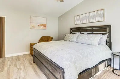 a bedroom with a bed and a chair at Pool Access and Private Deck Mtn-View Bonita Studio in Bonita