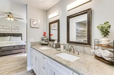 a bathroom with two sinks and a large mirror at Pool Access and Private Deck Mtn-View Bonita Studio in Bonita
