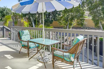 a table and two chairs and an umbrella on a patio at Pool Access and Private Deck Mtn-View Bonita Studio in Bonita