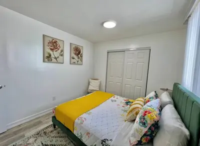 a bedroom with a bed with a yellow blanket at Central San Diego 2 BED Condo in San Diego