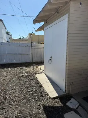 a white garage door with a bike stencil on it at Cozy cottage in San Diego